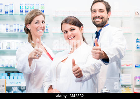 Pharmacists in pharmacy showing thumbs up Stock Photo