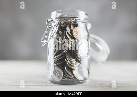 Coins in a glass jar Stock Photo