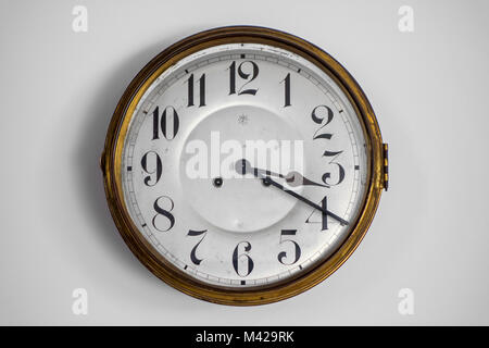 Vintage circular wall clock from the early twentieth century made by Junghans Uhren GmbH, German watch and clock manufacturer Stock Photo