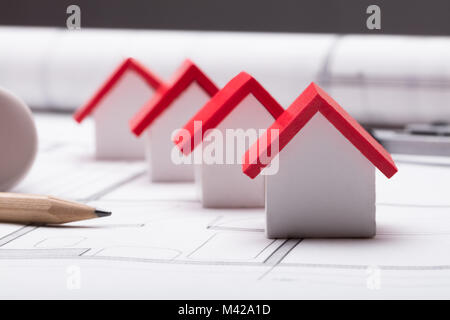 Close-up Of Pencil And House Model With Red Roof On Blueprint Stock Photo