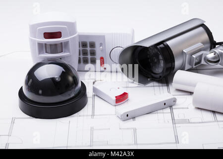 Photo Of Security Equipment On Blueprint In Office Stock Photo