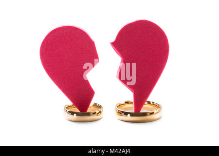 High Angle View Of Golden Ring On Red Broken Heart On White Background Stock Photo