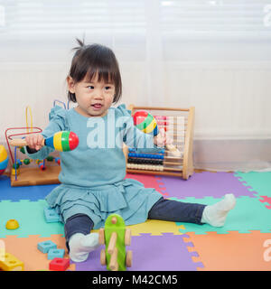 baby girl play maracas at home Stock Photo