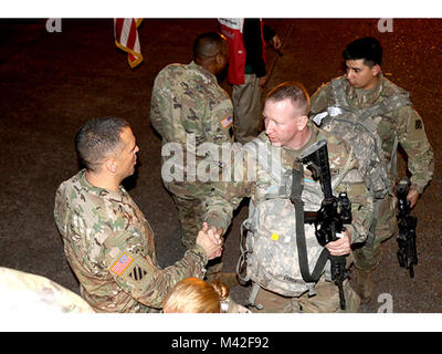 Task Force Marne commander, Brig. Gen. Sean Bernabe, shakes the hand of each Soldier from 1st Armored Brigade Combat Team, 3rd Infantry Division, as they board the plane for South Korea in  support of the brigade's nine-month rotation. Stock Photo