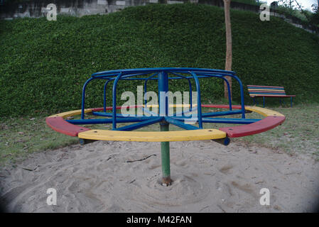 An empty colorful roundabout at a playground. Stock Photo