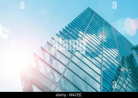 Architecture of modern skyscraper in business district with sun light. Smart city business background concept or use for website background. Stock Photo