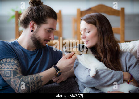 Young couple with pet puppy Jack Russell Stock Photo
