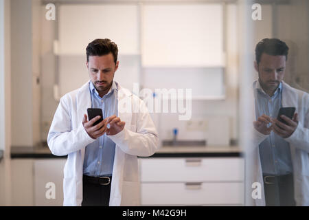 Male scientist using smartphone in laboratory Stock Photo