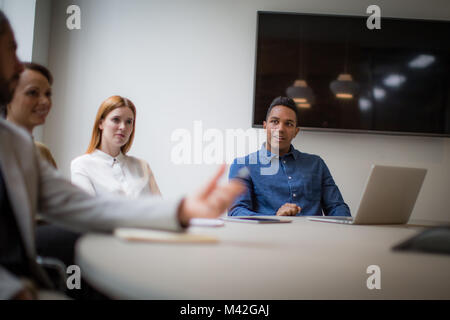 Colleagues having a discussion in a business meeting Stock Photo