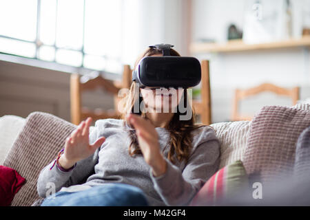 Young adult female using VR headset Stock Photo