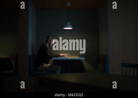 Businessman working late at night in office alone Stock Photo