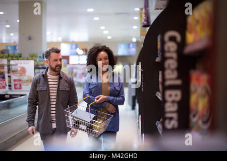 Couple doing weekly grocery shop together Stock Photo