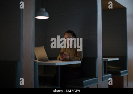 Businesswoman working late at night in office alone Stock Photo