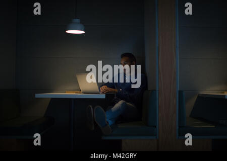 Businessman working late at night in office alone Stock Photo