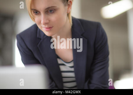 Young adult female looking at a laptop Stock Photo