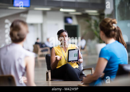 Businesswoman in a meeting using a digital tablet Stock Photo