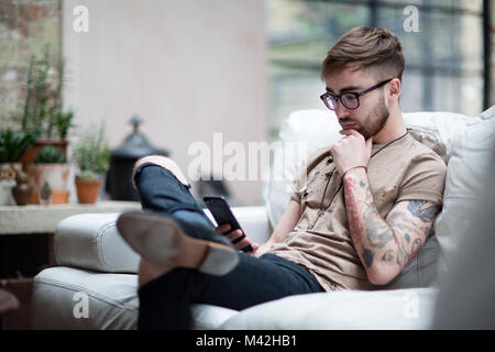 Young adult male on smartphone Stock Photo