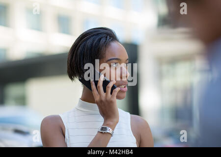 Businesswoman on way to work using smartphone Stock Photo