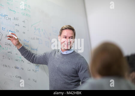 Teacher giving a class at college Stock Photo