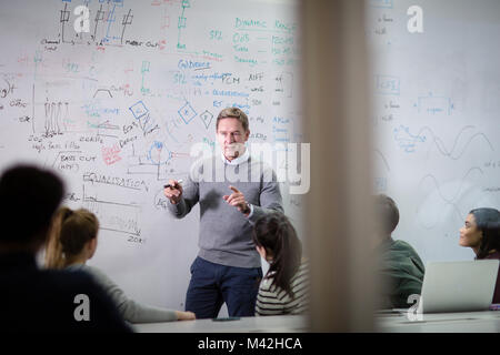 Teacher giving a class at college Stock Photo