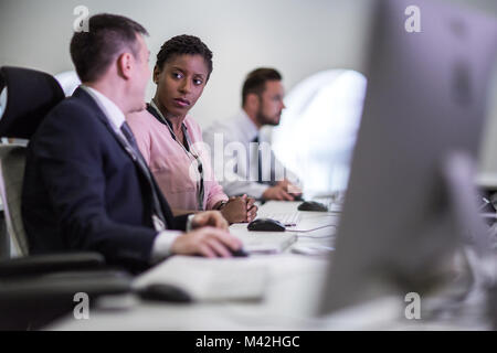 Colleagues in an office talking together Stock Photo