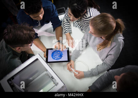 Group of students looking at design for 3D printer Stock Photo
