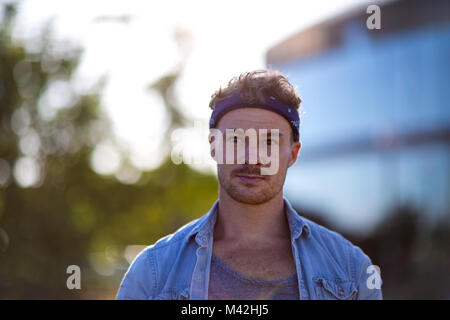 Young adult walking down street Stock Photo
