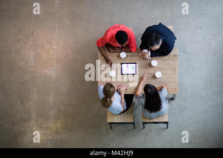 Overhead shot of a team using a digital tablet in a business meeting Stock Photo