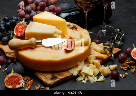 Whole round Head of parmesan or parmigiano hard cheese and wine Stock Photo