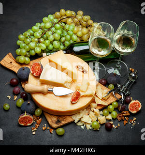 Whole round Head of parmesan or parmigiano hard cheese and wine Stock Photo