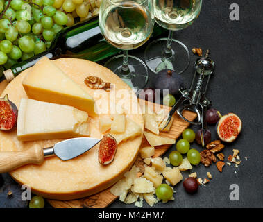 Whole round Head of parmesan or parmigiano hard cheese and wine Stock Photo