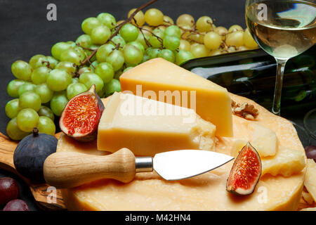 Whole round Head of parmesan or parmigiano hard cheese and wine Stock Photo