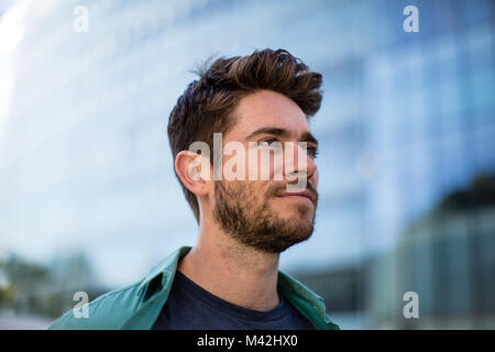 Young adult walking down street Stock Photo