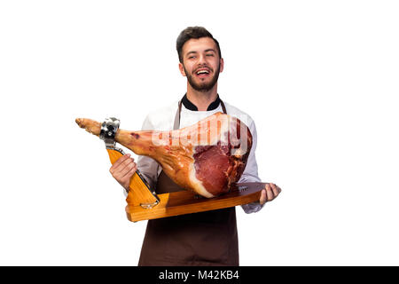 happily laughing chef with smoked pork leg in hands Stock Photo