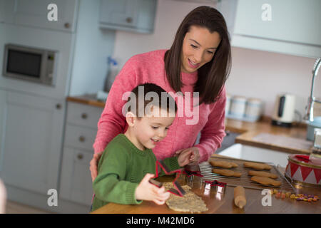 Mother and Son baking cookies in kitchen Stock Photo