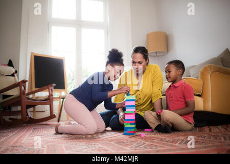 Mum with Kids building a tower Stock Photo