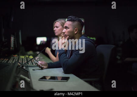 Operators in a control room at a television studio Stock Photo