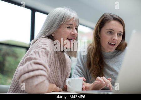 Mother and Daughter using a laptop together Stock Photo
