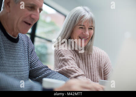 Senior couple using a laptop together Stock Photo