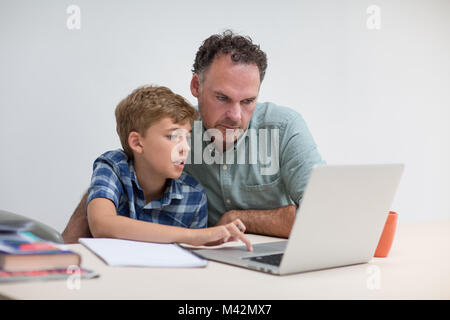 Father helping son with homework Stock Photo