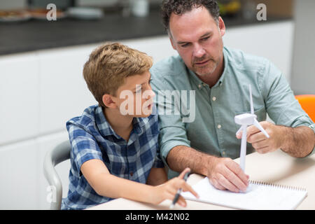 Father helping son with school project Stock Photo