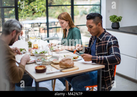 Friends enjoying a meal together Stock Photo