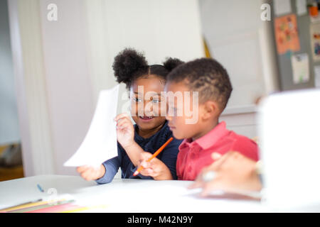 African American holding up school work proudly Stock Photo