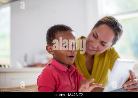 Boy playing on digital tablet Stock Photo