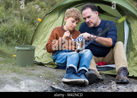 Father teaching Son how to fish Stock Photo