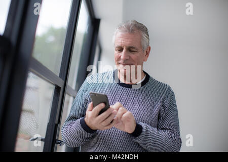 Senior man using smartphone Stock Photo
