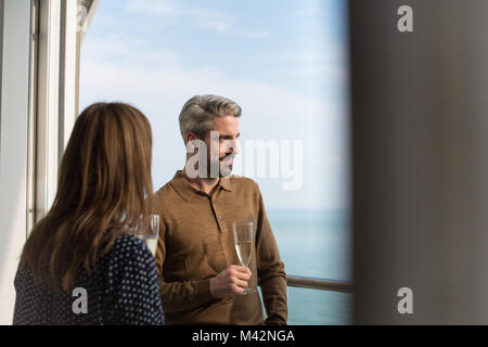 Couple enjoying view from balcony of sea Stock Photo