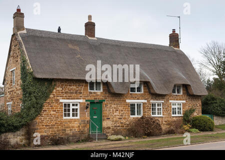 An image of a thatched cottage taken on a Winter's day in Rockingham, Northamptonshire, England, UK Stock Photo