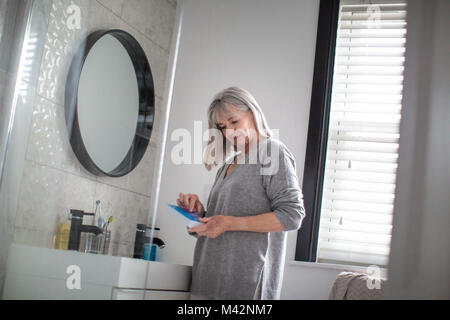 Senior woman taking medicine Stock Photo