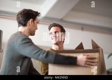 Young male couple moving home Stock Photo